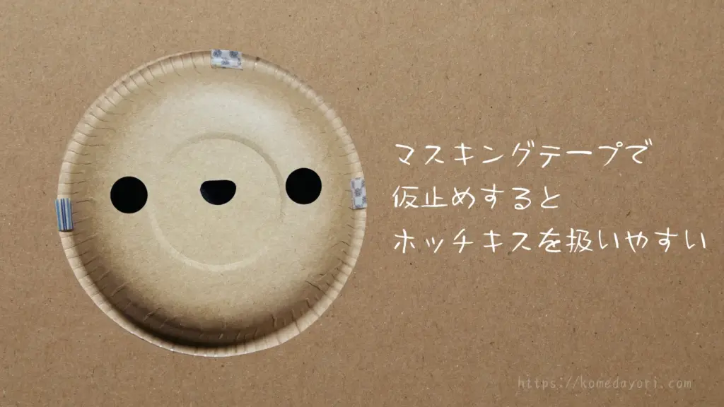 紙ボウル同士を重ね、マスキングテープで仮固定している様子。「マスキングテープで仮止めするとホッチキスを扱いやすい」という文字が入っている。