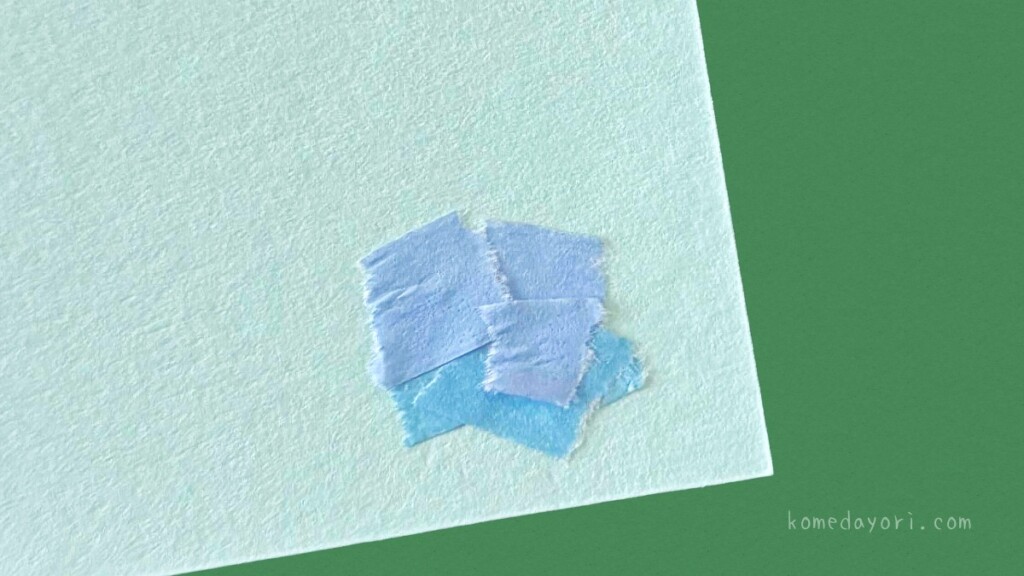 子ども向けの簡単な紫陽花工作:水色と青色のマスキングテープをちぎって画用紙に貼る様子